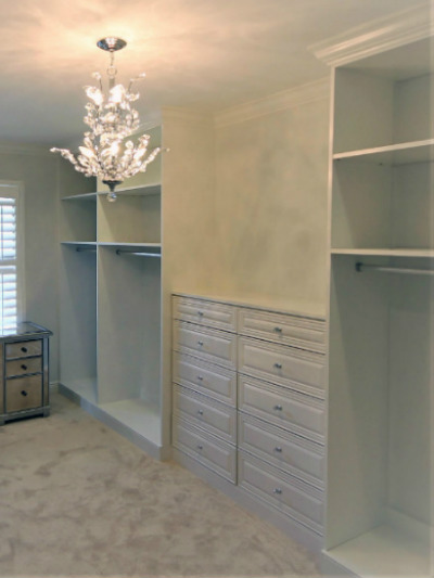 white closet organizer with crown molding